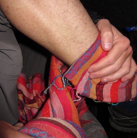 Jack making a makeshift thermal using my scarf on the freezing night bus to Merzouga