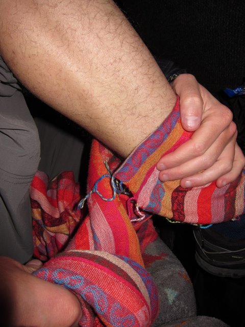 Jack making a makeshift thermal using my scarf on the freezing night bus to Merzouga