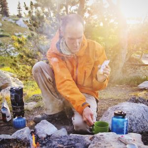 Dinner preparation. The smoke helps keep mosquitoes at bay.